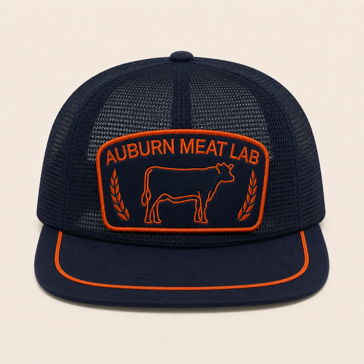 Straight-on front view of the Auburn Meat Lab cap showing its embroidered patch and flat braided visor cord.
