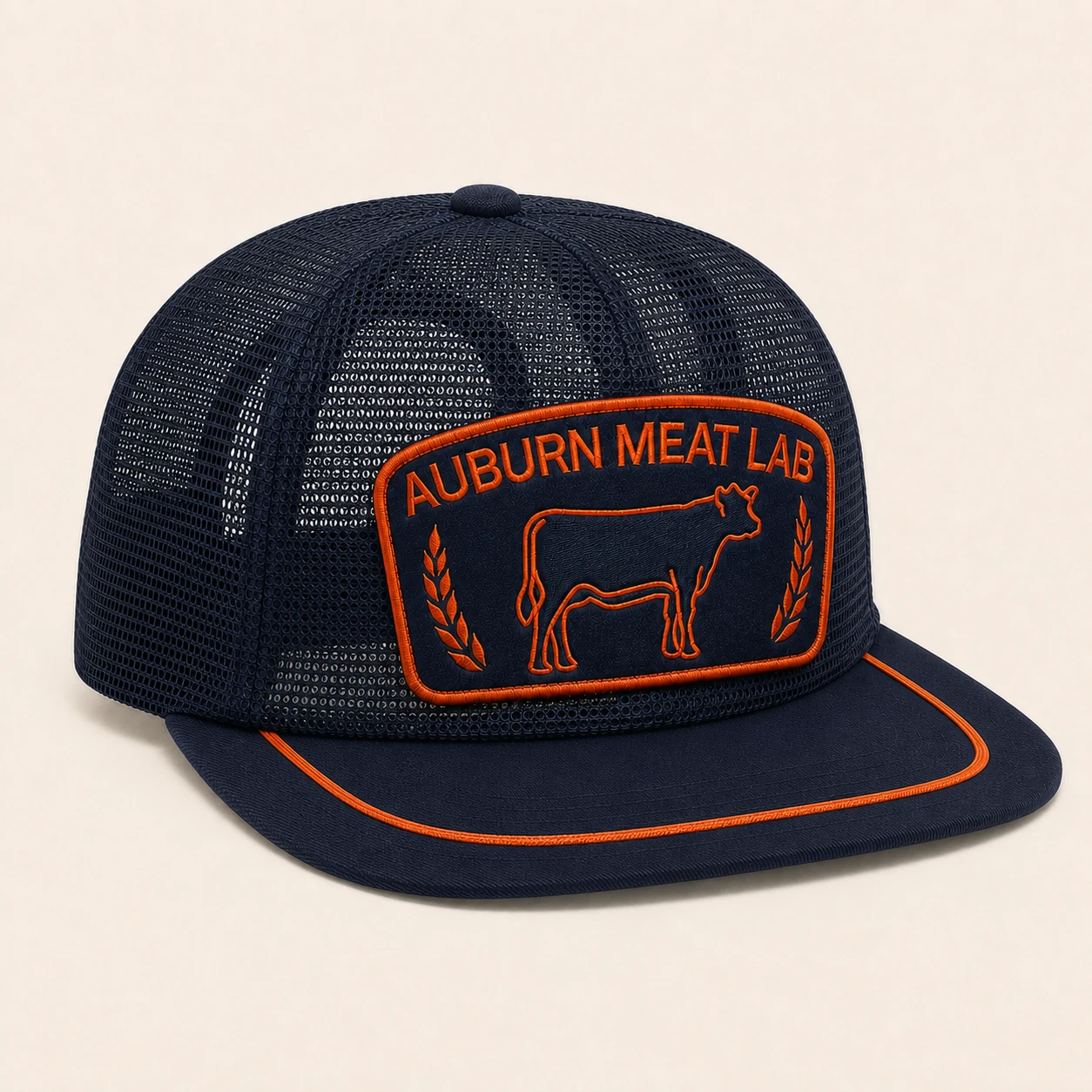 Three-quarter view of the navy and orange Auburn Meat Lab all-mesh snapback cap.