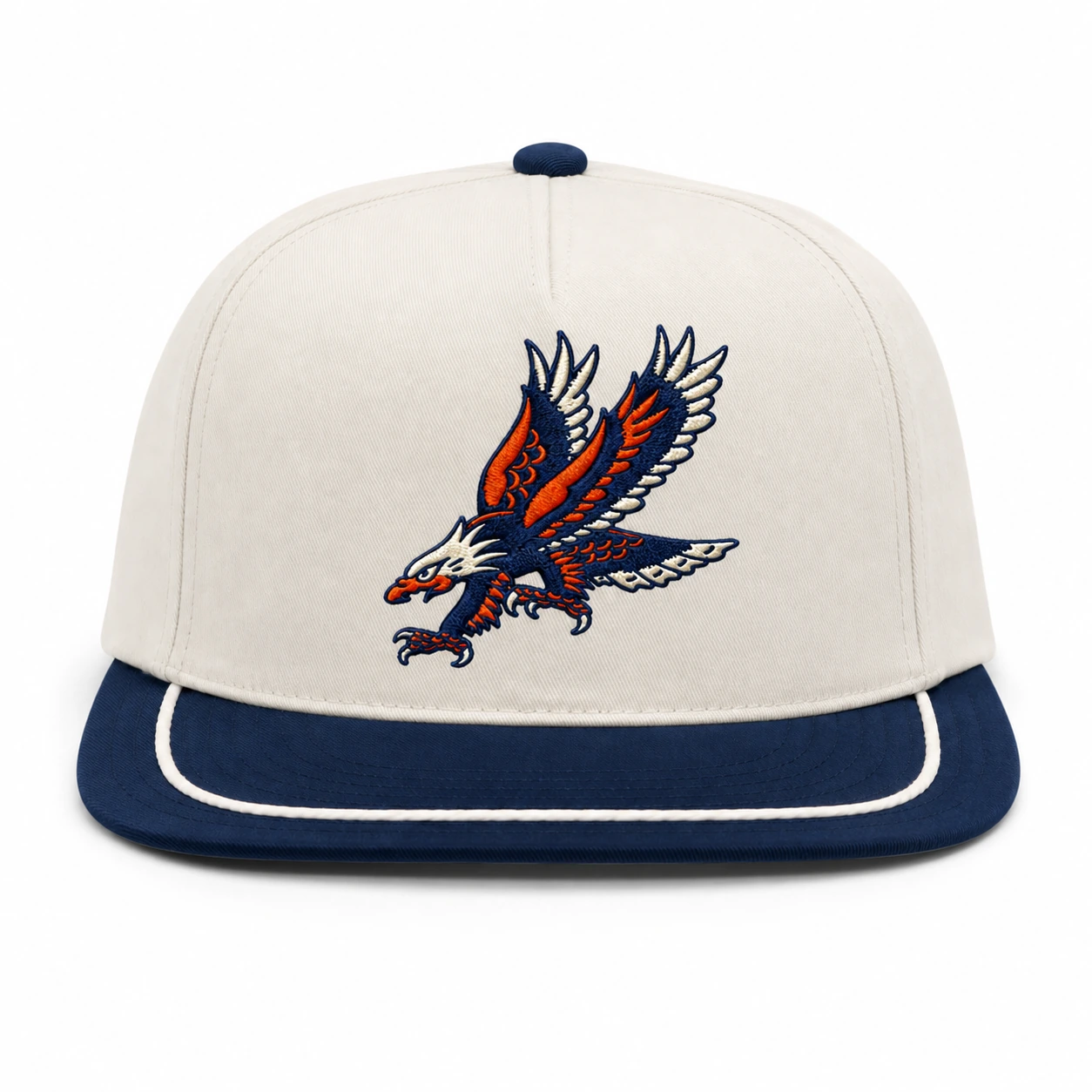 Straight-on front view showing the single front panel, direct eagle embroidery, flat navy visor, and cream braided trim.
