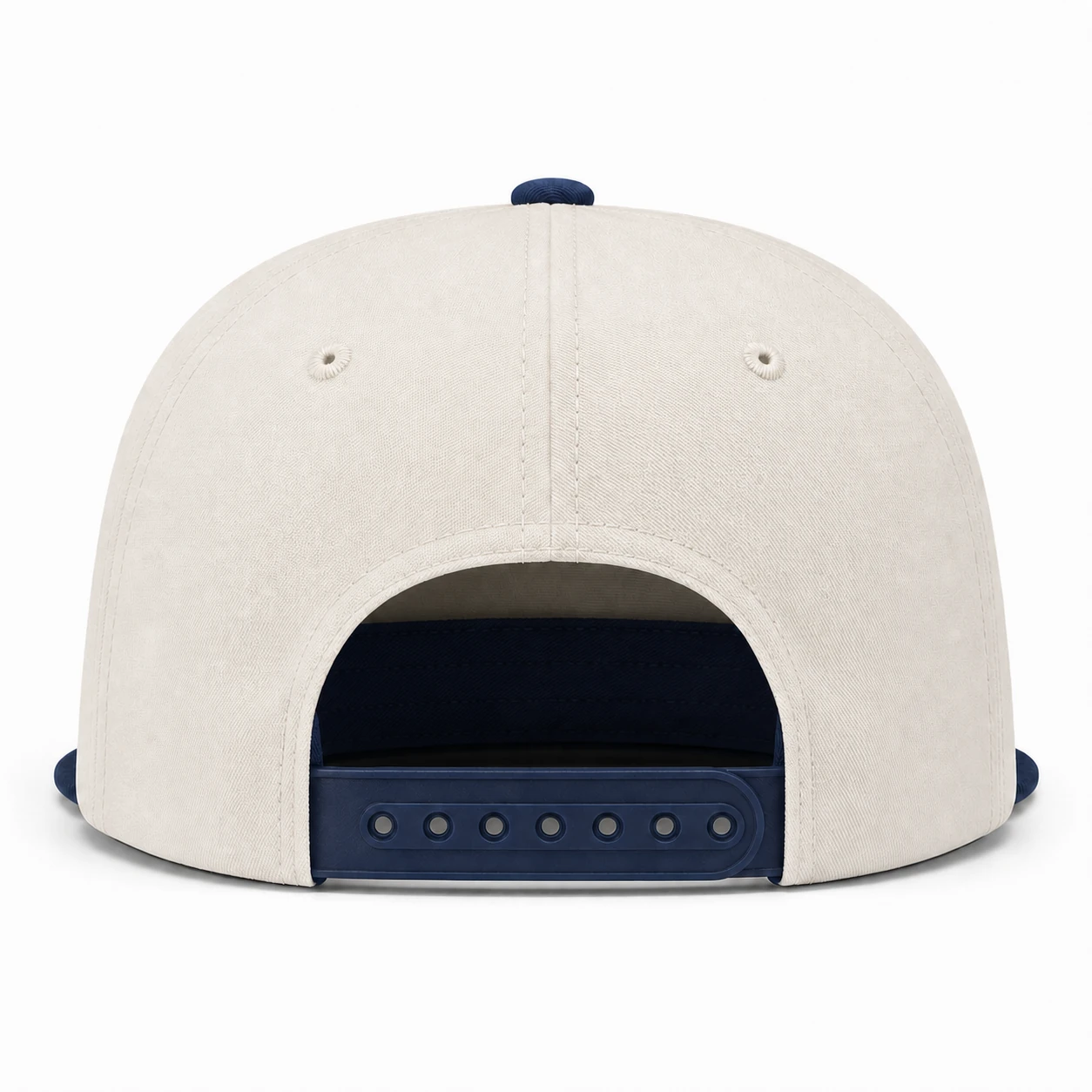 Straight rear view showing the cream five-panel crown and navy adjustable snapback closure.