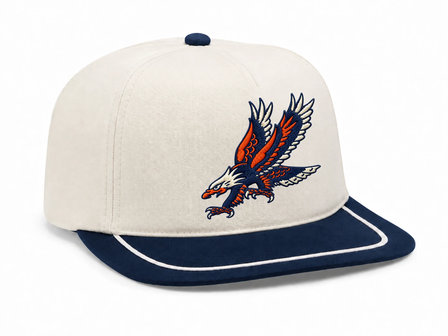 Three-quarter view of the cream and navy Raptor Performance Hat with embroidered eagle artwork.